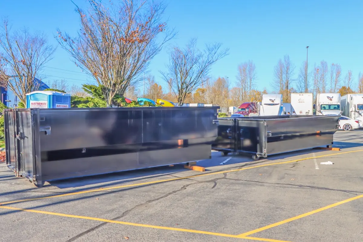 Professional dumpster rental service with roll-off container on residential driveway in Floris